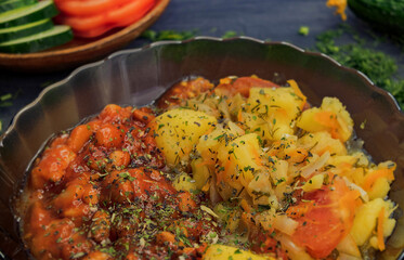 Beans in sauce and potatoes with carrots in a brown transparent deep dish