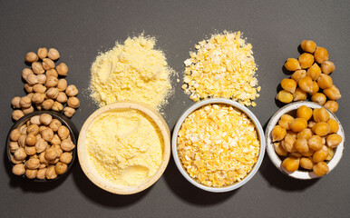 Raw and cooked chickpeas, chickpea flour and flakes in small ceramic plates, isometric projection diagonal on a black background. Vegetarian dish. style minimalism. healthy vegetarian food concept