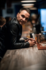 Portrait of a handsome young man. Shooting in a bar