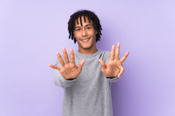 Young african american man isolated on purple background counting nine with fingers
