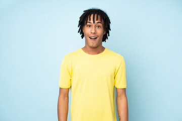 Young african american man isolated on blue background with surprise facial expression