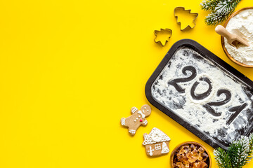 Flat lay of Christmas cooking with icing gingerbread cookies, top view