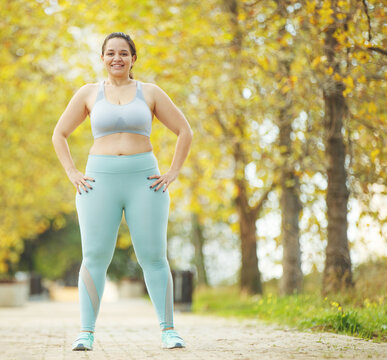 Fat woman jogging, doing sports for weight loss, obesity problem. High quality photo.