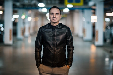 Naklejka premium Portrait of a handsome young man. Shooting in a car park