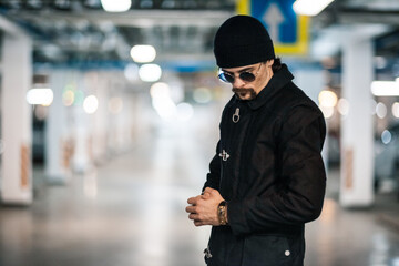Portrait of a handsome young man. Shooting in a car park