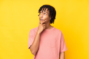 Young african american man isolated on yellow background thinking an idea