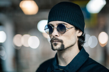 Portrait of a handsome young man. Shooting in a car park