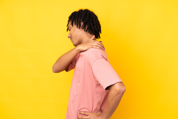 Young african american man isolated on yellow background suffering from pain in shoulder for having...