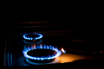 ignition of gas with a hand lighter at night, the foreground and background are blurred with bokeh effect