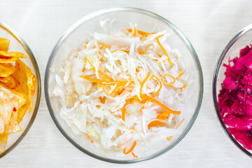 Sauerkraut, cabbage kimchi and beet sauerkraut. Fermented preserved vegetarian food. Top view.
