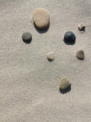 Fototapeta na wymiar Colorful stones on sand. Background.