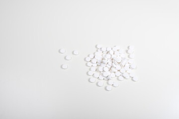 Pills scattered on a white cloth.