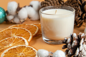 dried oranges, citrus fruits, white candle, glass with white wax, holiday on the table, christmas.