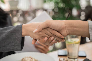 Close up both hands shaking in a cafe agreed mutual agreement