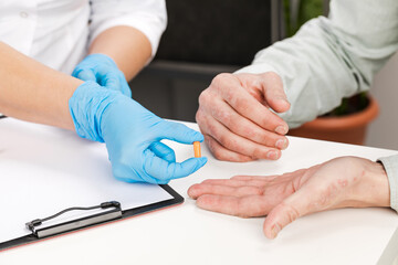 The dermatologist examines the skin of the patient the patient holds in his hands a cure for the belezney. Examination and diagnosis of skin diseases-allergies, psoriasis, eczema, dermatitis.