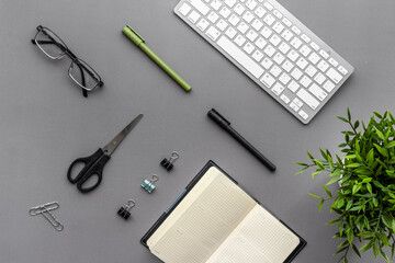 Flat lay office workplace with keyboard and office supplies, top view