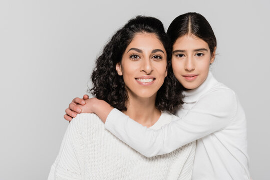 Hispanic Daughter Hugging Mother Isolated On Grey, Two Generations Of Women