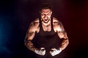 Fototapeta na wymiar Sportsman muay thai boxer fighting on black background with smoke. Sport concept.