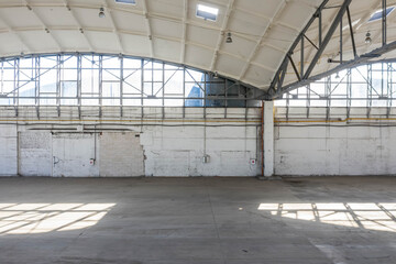 Wall of huge empty industrial warehouse. Modern interior. Unique soviet architecture. Hemispherical reinforced concrete load bearing roof.