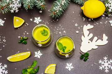 Low alcoholic cocktail limoncello with Christmas decoration, fresh citrus and mint