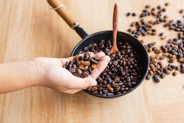 .Roasted coffee beans in hand