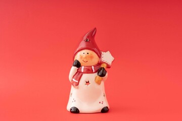 Porcelain Christmas toy isolated on a red background. Holiday and winter concept.