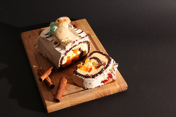 Food - Beautiful birthday cake on a wooden board. The background is black.