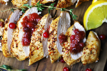 Juicy slices of turkey fillet with cranberry sauce. Festive food. Christmas mood.