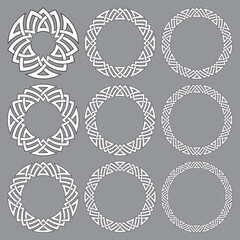Set of round frames. Nine decorative elements for design with stripes braiding borders. White lines with black strokes on gray background.