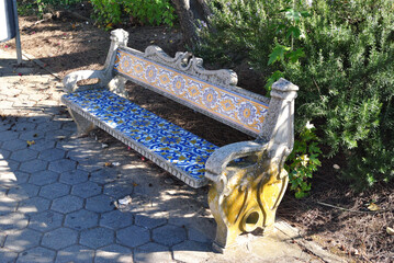 Close Up of Empty Public Concrete Bench Decorated with Colourful Ceramic Tiles 