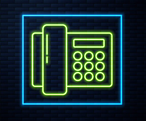 Glowing neon line Telephone icon isolated on brick wall background. Landline phone. Vector Illustration.