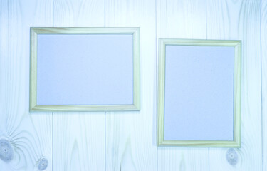 Mock up two empty wooden frames on light-blue pine wood wall background, show text or product.
