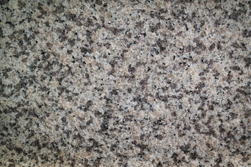 Rough-textured hard granite surface background