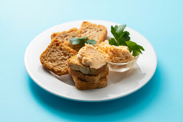 toasts with fish pate on white plate