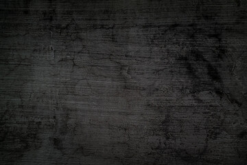 Rough, black-gray concrete wall background with crack and horizontal stripes.