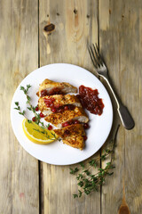 Juicy turkey fillet in slices with cranberry sauce on a plate. Festive food.