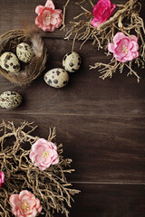 easter eggs and flowers on rustic wooden background. quail eggs