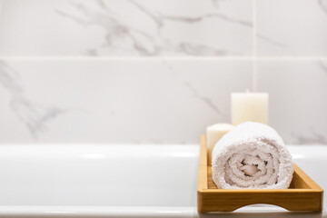 Obraz na płótnie Canvas Close up view of marble white bathroom accessories, white towels, candles and copy space