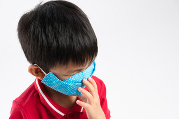 Asian boy wearing reusable homemade cloth face mask on white background