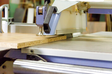 Format-cutting machine in production close-up. Woodworking machine. Circular saw