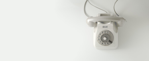 A white vintage dial telephone with white background.