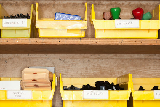 Containers with stationery on shelves.