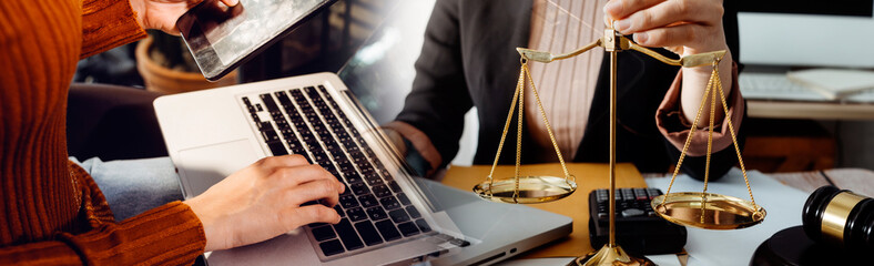 Fototapeta premium Business and lawyers discussing contract papers with brass scale on desk in office. Law, legal services, advice, justice and law concept picture with film grain effect