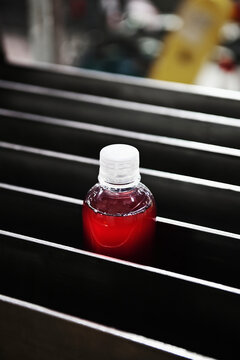 Bottle in processing machinery in packaging plant.