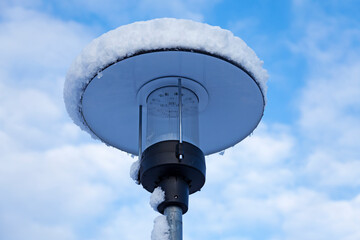 street lamp covered with fresh snow