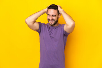 Young caucasian handsome man isolated on yellow background laughing