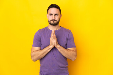 Young caucasian handsome man isolated on yellow background scheming something