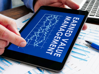 The manager reads Earned Value Management EVM report.