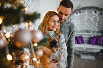 Picture showing young couple hugging over Christmas tree