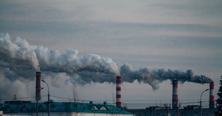 industrial chimneys with smoke on gray sky background. Smokestack Pollution in the air as environmental problem